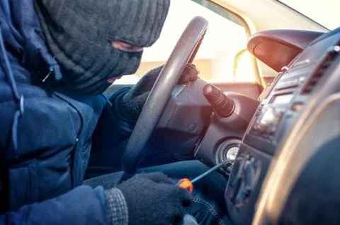 Car thief trying to start auto with screwdriver Stock Photos