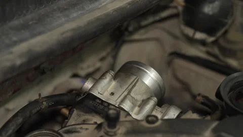Car throttle body assembly installed on engine inside dusty bay. Stock Footage 341487147