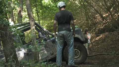 Car tied with string and pulled out of a ravine Stock Footage 100861701