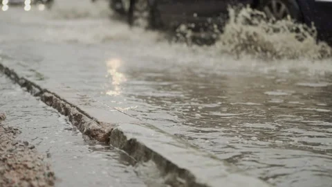 Car Tire Creating Water Splash on Wet Urban Road 스톡 동영상 340482938