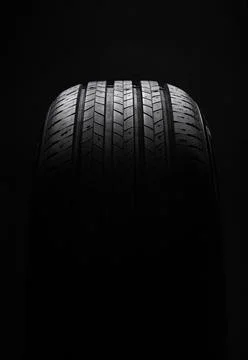 Car tire on dark background with dramatic lighting Foto stock