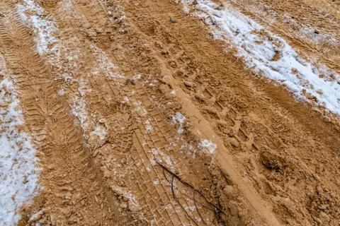 Car Tire Marks on an Empty Field Covered With Snow, closeup view - Cloudy Day 写真素材