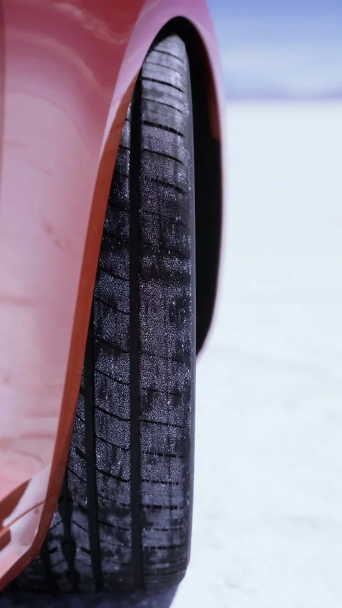 Car tire on salt flat surface under clear sky during daylight hours Stock Footage 329939529