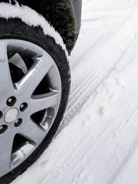 Car tire in snow with tread pattern Stock Photos