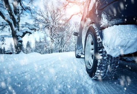Car tires on winter road Stock Photos