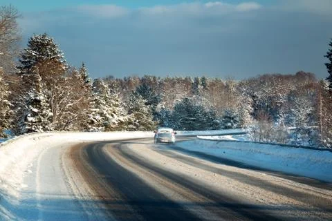 Car tires on winter road Stock Photos