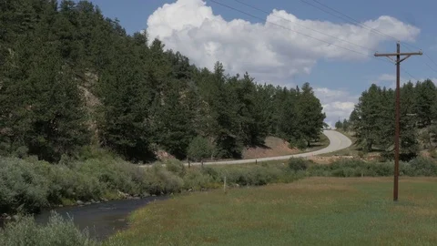 Car Toward Camera on Highway with River in Lake George CO Stock Footage 85214272