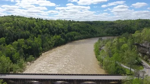 Car Tracking on a Bridge over a Fast Flowing River Kentucky Drone Aerial View Stock Footage 143983124