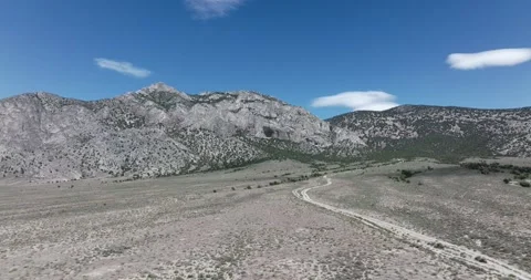 Car Tracking on a Desert Road Drone Aerial View Stock Footage 221096720