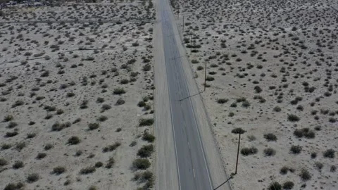 Car Tracking Through Wind Turbines In Palm Springs Desert California Drone Stock-Footage 335315724