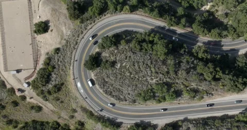 Car Tracking Winding Road in Affluent Pacific Palisades Los Angeles Drone Aerial Stock Footage 194748144