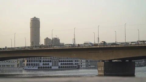 Car traffic on the 6th October Bridge at dusk. River Nile in central Cairo. Stock Footage 124986511