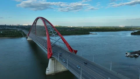 Car traffic on the arch road bridge across the river Stock Footage 202026726