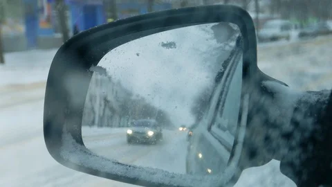 Car traffic in a blizzard, snowfall. Bad non-flying weather in city Stock Footage 93776403