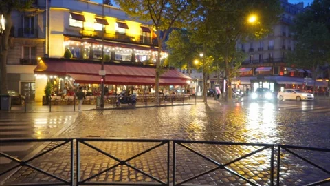 Car traffic driving through rain on an urban street in Paris France Stock Footage 90032852