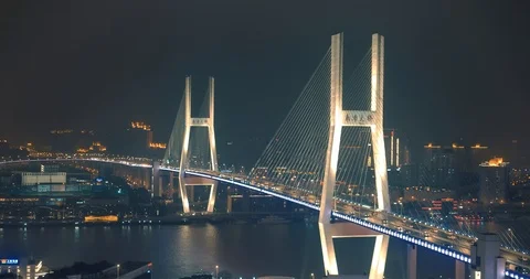 Car traffic moving on multi row Spiral Nanpu bridge in the evening, Shanghai Stock Footage 107810685