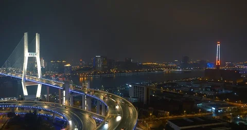 Car traffic moving on multi row Spiral Nanpu bridge in the evening, Shanghai Stock Footage 107810748