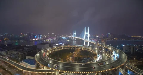 Car traffic moving on multi row Spiral Nanpu bridge in the evening, Shanghai Stock Footage 107810759