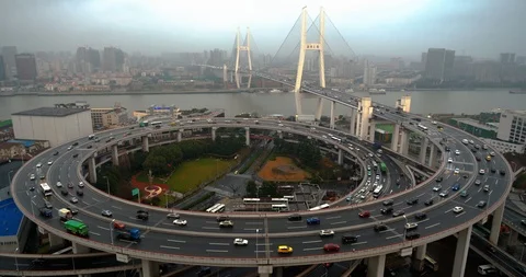 Car traffic moving on multi row Spiral Nanpu bridge in the evening, Shanghai Stock Footage 107810811