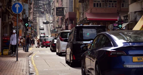 Car traffic navigating Eastern St, incline on background, Hong Kong island views Stock Footage 309363050
