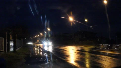 Car traffic at night in the rain Stock Footage 131385244