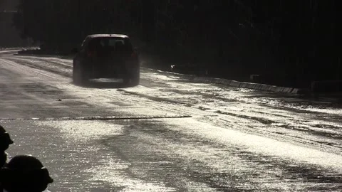 Car traffic in the rain with sun Video stock 166458450