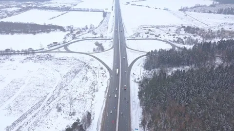 Car traffic on road junction at winter highway aerial view Stock Footage 86360295