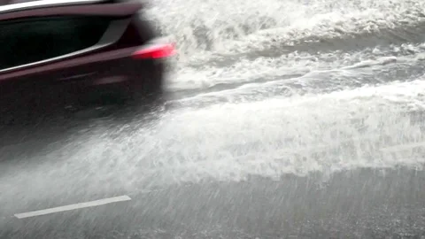 Car traffic splash the puddle on highway swiftly. Static long shot Stock Footage 74228824