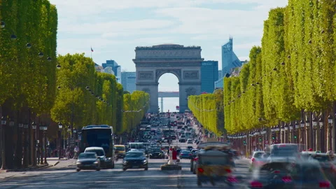 Car traffic in the summer on the Champs-Elysees, with the Arc de Triomphe Stock Footage 327647405