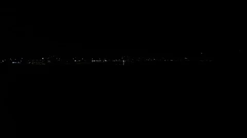 Car traffic in tromsoe city night with landing airplane Stock Footage
