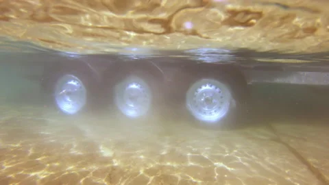 Car trailer wheels drive on the seabed. Underwater shot. Mediterranean in Greece Video stock 229238199