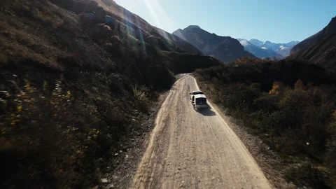 A car with trailers rides in the mountains on serpentines Stock Footage 171298947