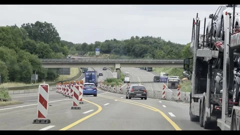 Car Transporting in Autobahn. Roadworks, expressway motorway highway Stock Footage 339882575