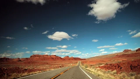 Car travelling down an empty desert road. Stock Footage 88342506
