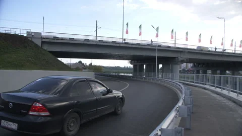 Car traverses road navigating turns and passing under bridge Stock Footage 262754971