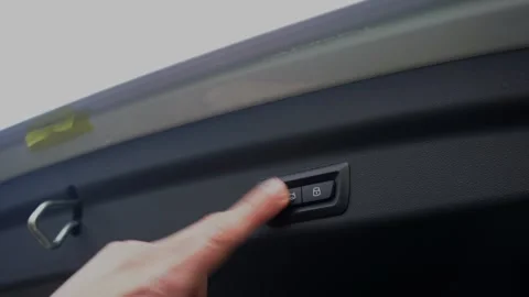 Car trunk closing button. Closing trunk on a car. Video stock 316255096