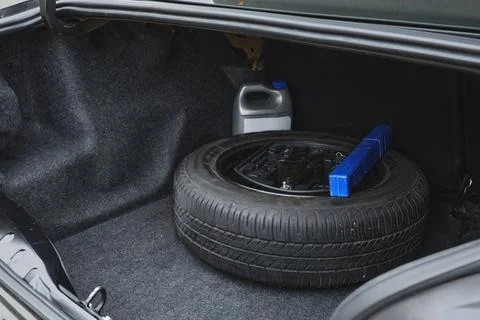 Car trunk containing spare tire and maintenance items Stock Photos