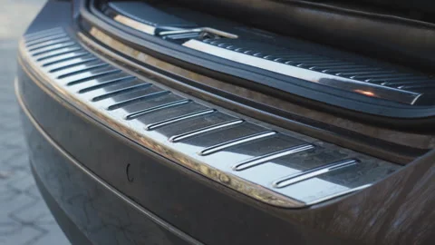 Car trunk door automatic opening with premium chrome bumper sill detail and Stock Footage 322951314