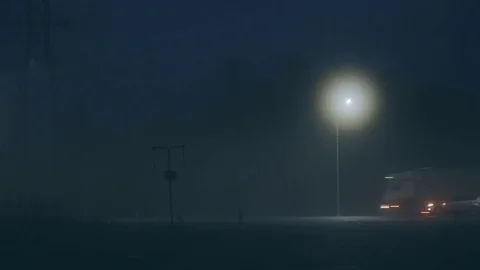 A car turning left on surreal dark night highway. Beautiful mysterious cinematic Stock Footage 83498628