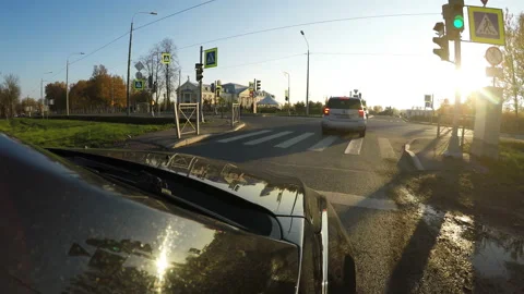 The car turns right on the intersection and continues to drive along the highway Stock Footage 106723111