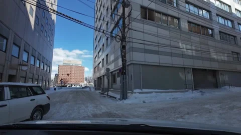 Car turns right at intersection in Hakodate winter city driving scene Video stock 333069378