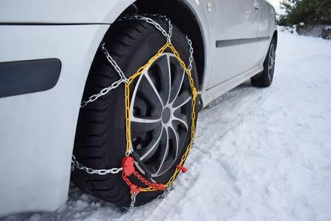 Car with tyre chains in winter Stock Photos