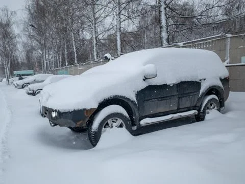 Car under a thick layer of snow Stock Photos