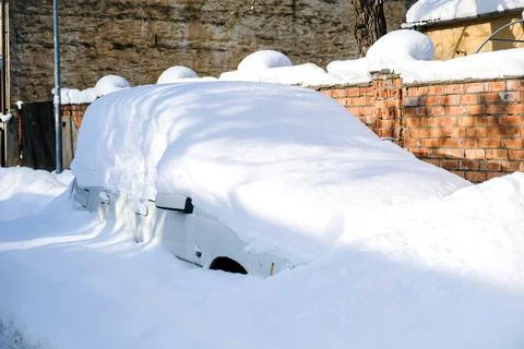 Car under a thick layer of snow after heavy snowfall Stock Photos