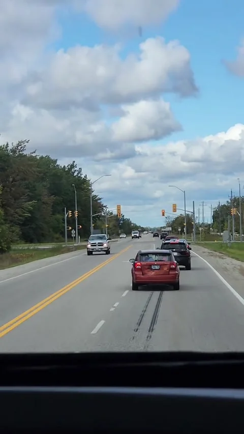 Car Uses Left Turn Lanes To Cut Traffic, Essex, Ontario, Canada - 16 Oct 2023 스톡 동영상 255444537