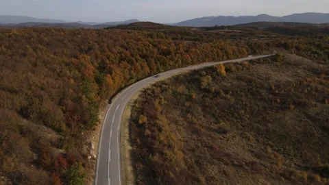Car vehicle drive on mountain range nature aerial view in autumn day Stock Footage 254023957