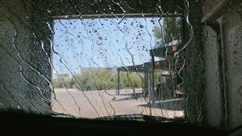 A in-car view of an automatic car wash captures the process from inside Stock Footage 319108496