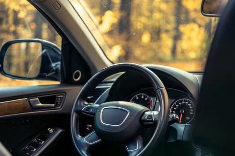 Car view from the inside. Car steering wheel and interior. Stock Photos
