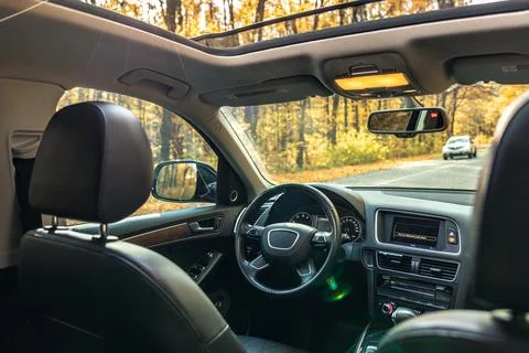 Car view from the inside. Car steering wheel and interior. Stock Photos