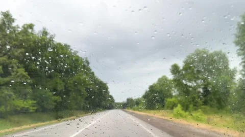 Car view on road with green trees and cloudy sky in rainy weather. Raindrop on Stock Footage 313612642